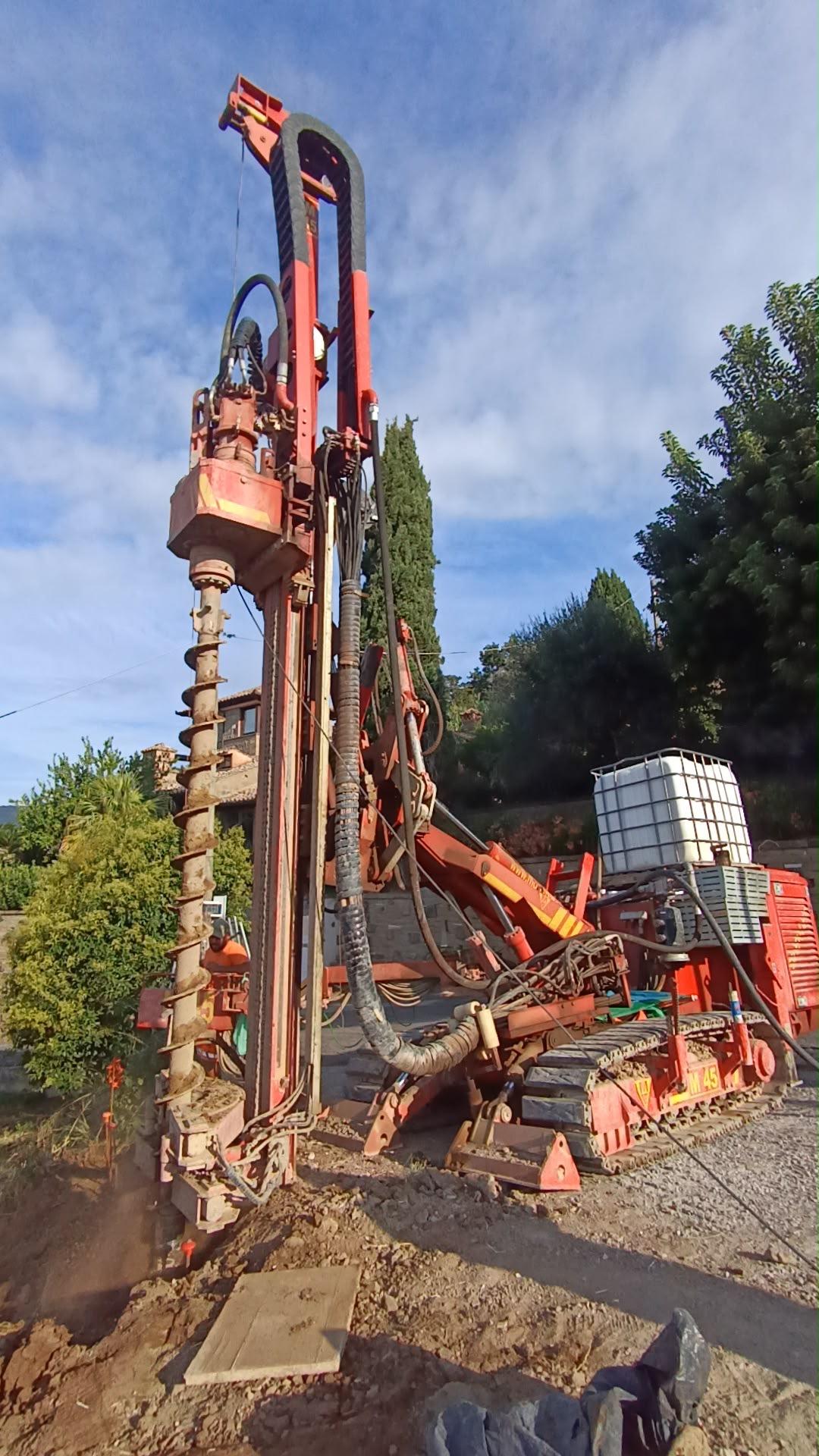 Red Mori M45 anchor and micropile drilling rig with auger bit drilling into the ground.